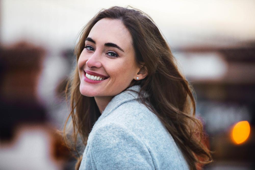 Middle aged woman with brown hair smiling after tmj treatment, centerville oh