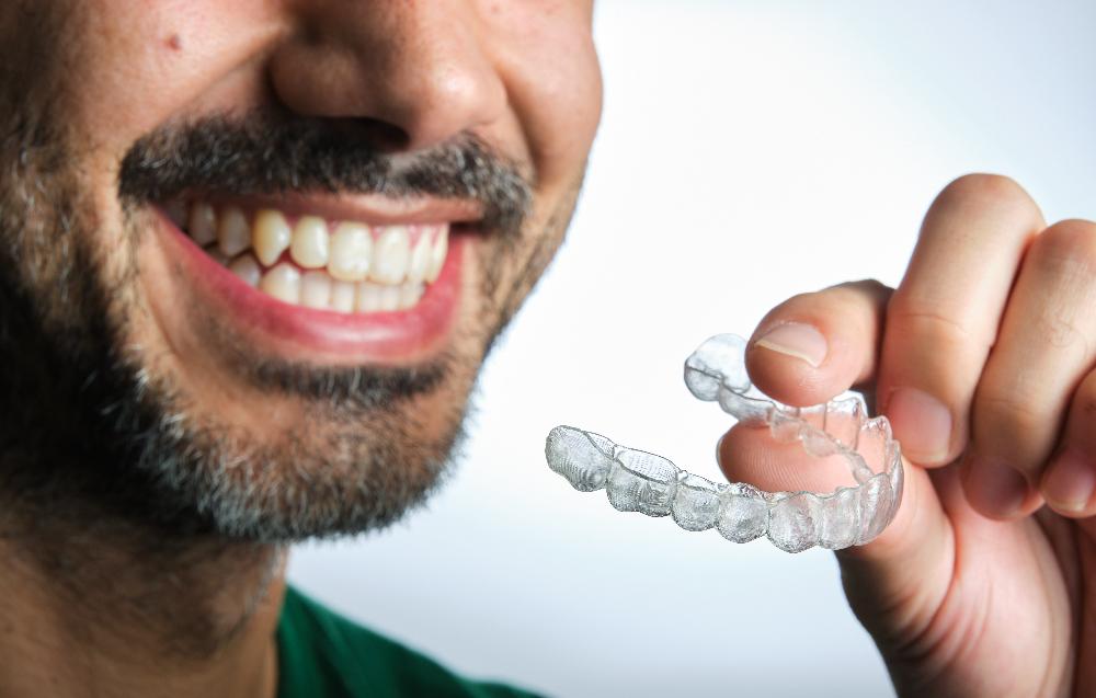 Man holding clear aligner, centerville oh