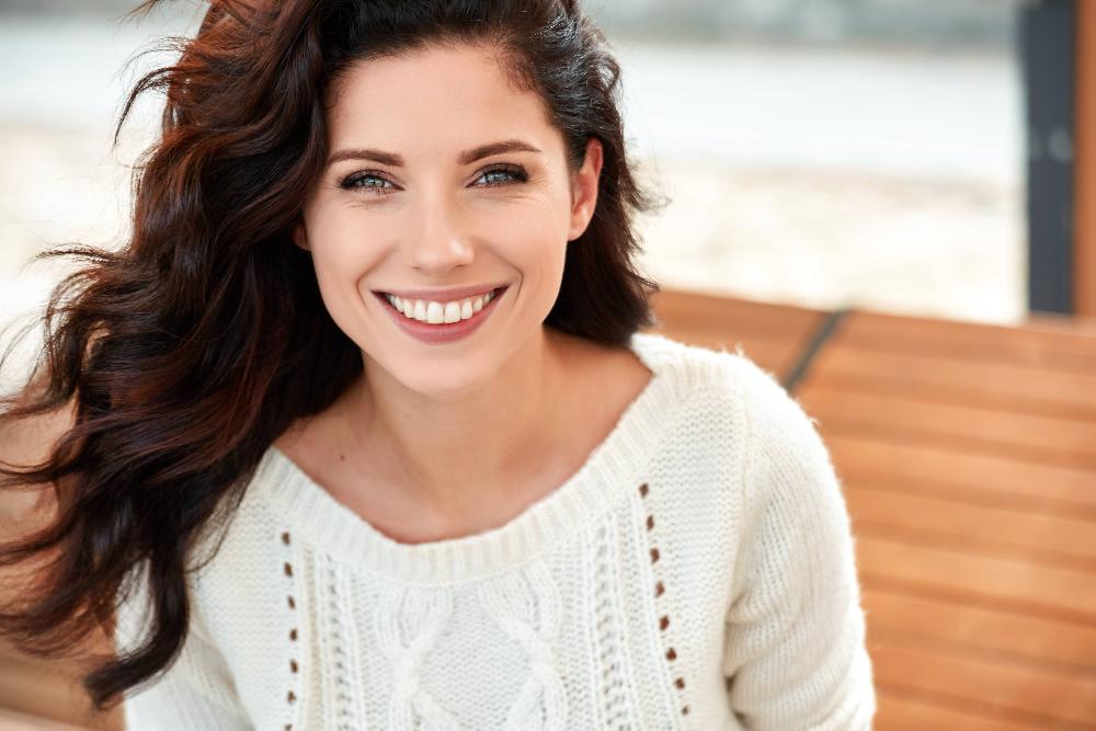 Young woman with red hair smiling after teeth whitening, centerville oh