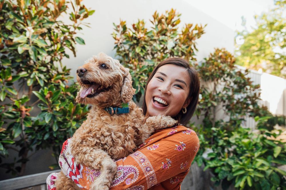 Young woman smiling holding a dog, centerville oh