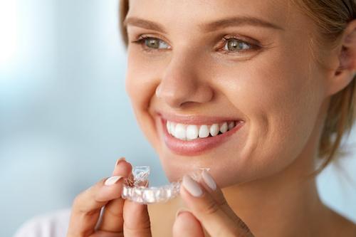 Young woman holding aligners, centerville oh
