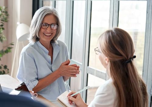 Older woman in glasses talking to younger woman, centerville oh