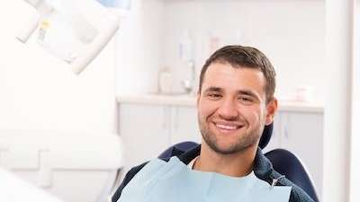 Young man smiling in dental chair, centerville oh