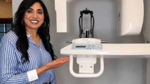 Dr. Linty Healing and showing technology within the office at ohio holistic dental center