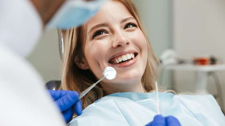 Women in dental chair smiling, centerville oh