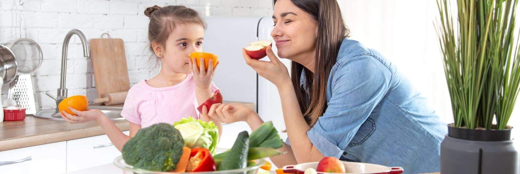 Mom and daughter smelling fruit in a kitchen, centerville oh